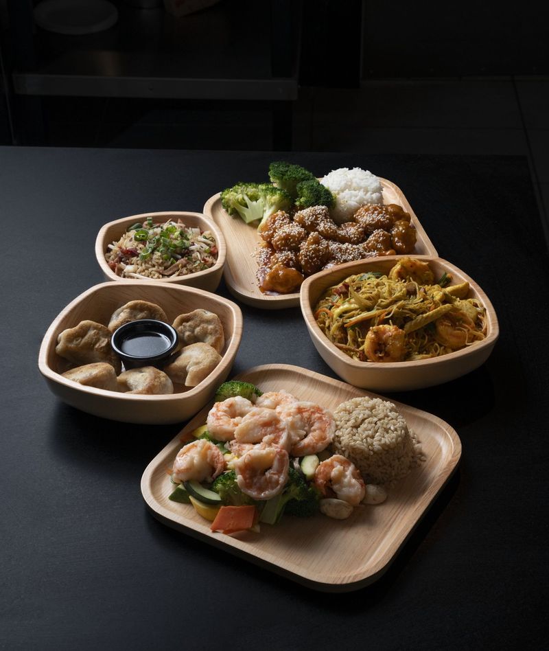 Several plated dishes arranged on a dark tabletop