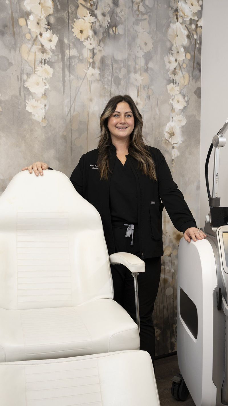 Woman standing beside a white treatment chair