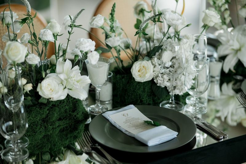 An elegant wedding reception table set with flowers