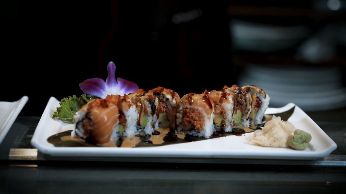 Finished sushi rolls with an orchid garnish at Yume