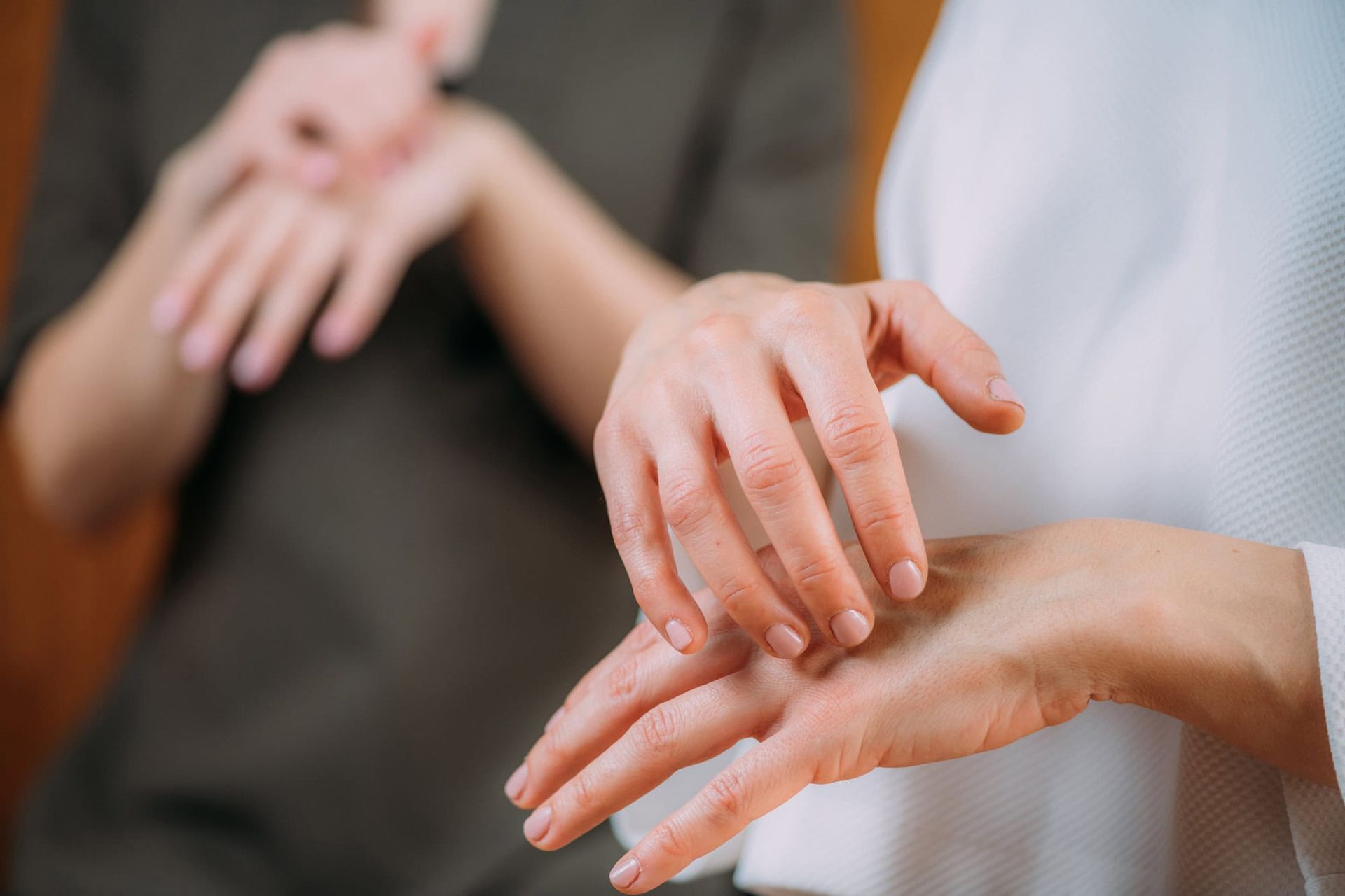 A woman is using sign language to communicate with another woman.