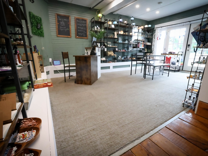 A large room with a carpeted floor and a wooden table