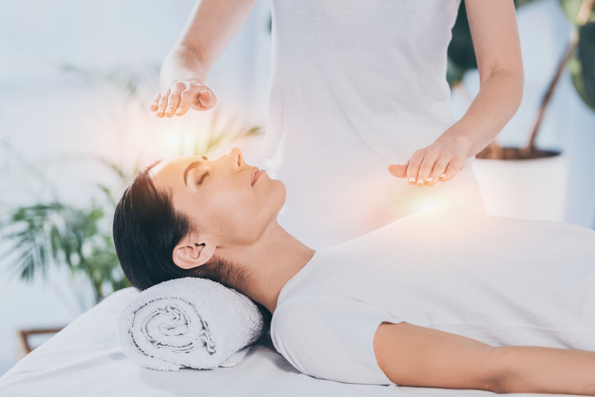 A woman is getting a healing treatment at a spa.