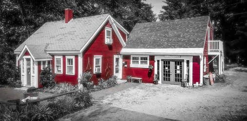 A black and white photo of a large red house
