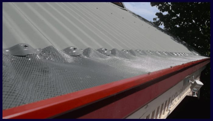 metal gutter guard installed along a roof edge