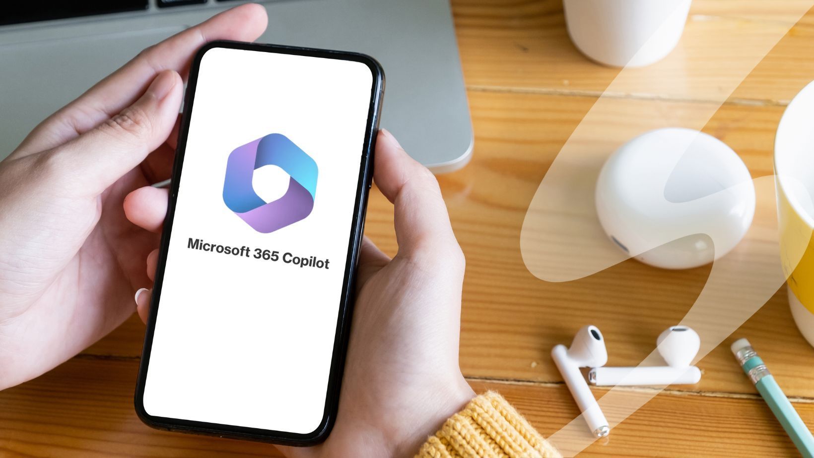 A person's hands holding a phone that has a Microsoft 365 Copilot splash screen
