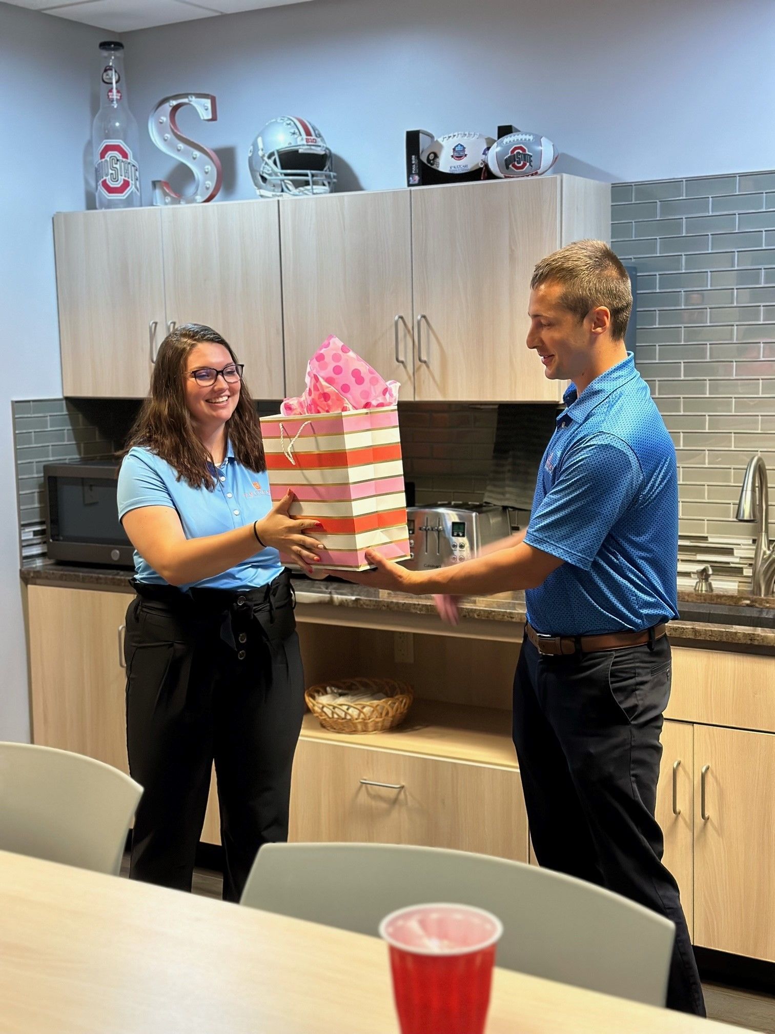 Hannah receiving a fit bag from Ed Barth