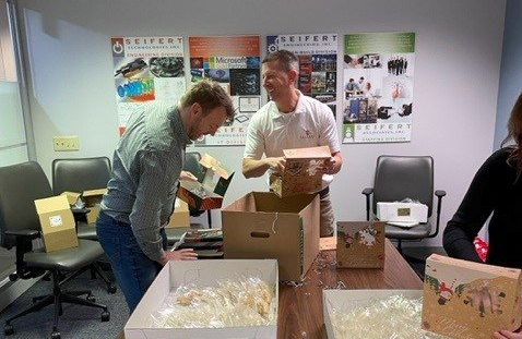 The Seifert team filling boxes with cookies for our friends and clients