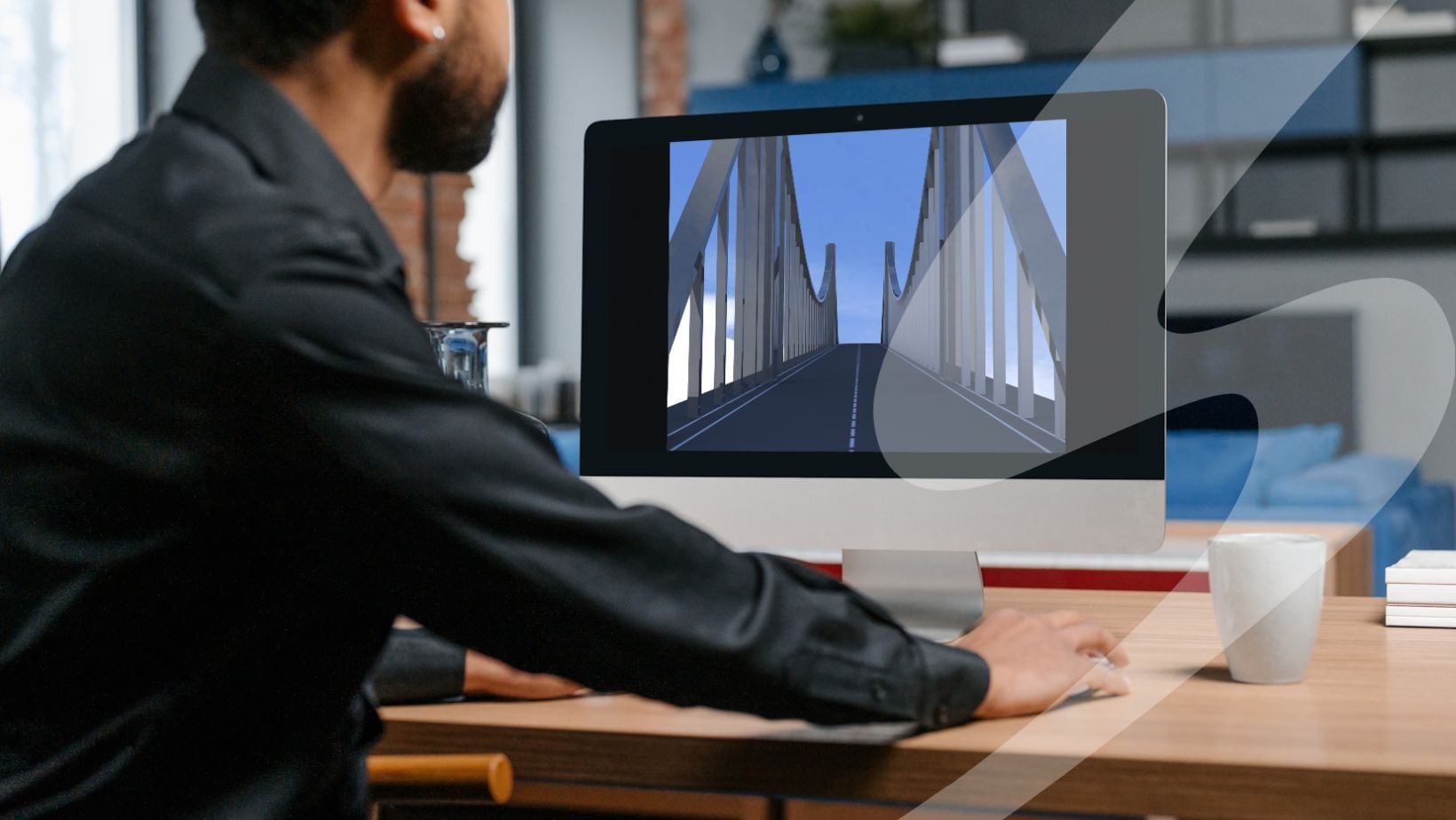 Man at a desk with a rendered 3D bridge on the computer screen