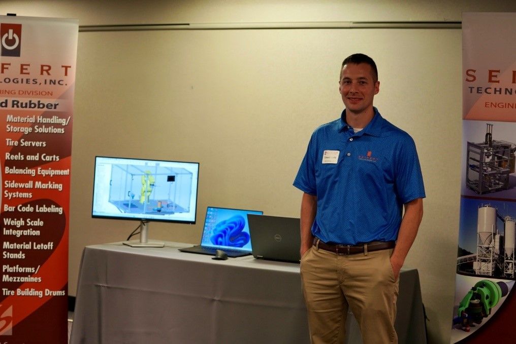 A Seifert employee in front of a display table.
