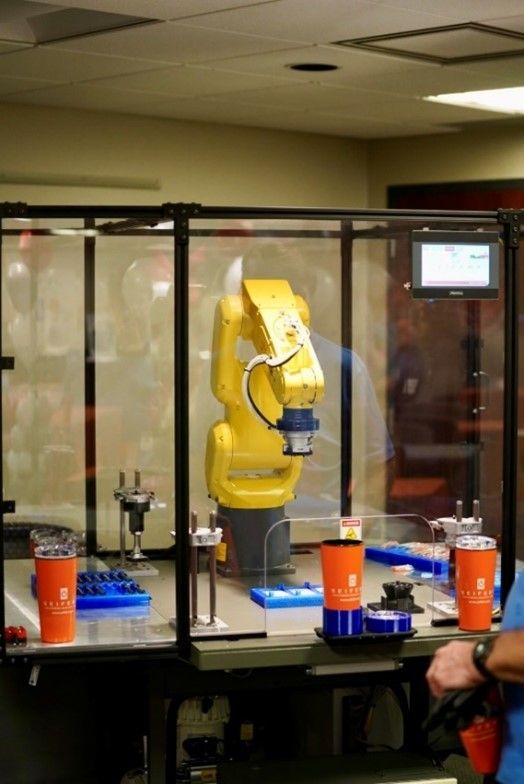 Robotic arm in a glass case