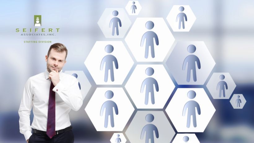 Man with left hand on chin appearing to be thinking. Seifert staffing logo top left.