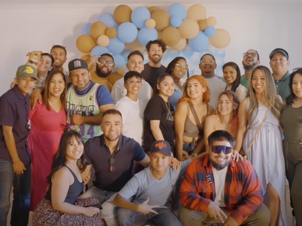 A large group of people are posing for a picture at a baby shower.