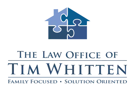 Logo for The Law Office of Tim Whitten featuring a house made of four puzzle pieces in blue shades and text below.