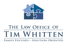 Logo for The Law Office of Tim Whitten featuring a house made of four puzzle pieces in blue shades and text below.