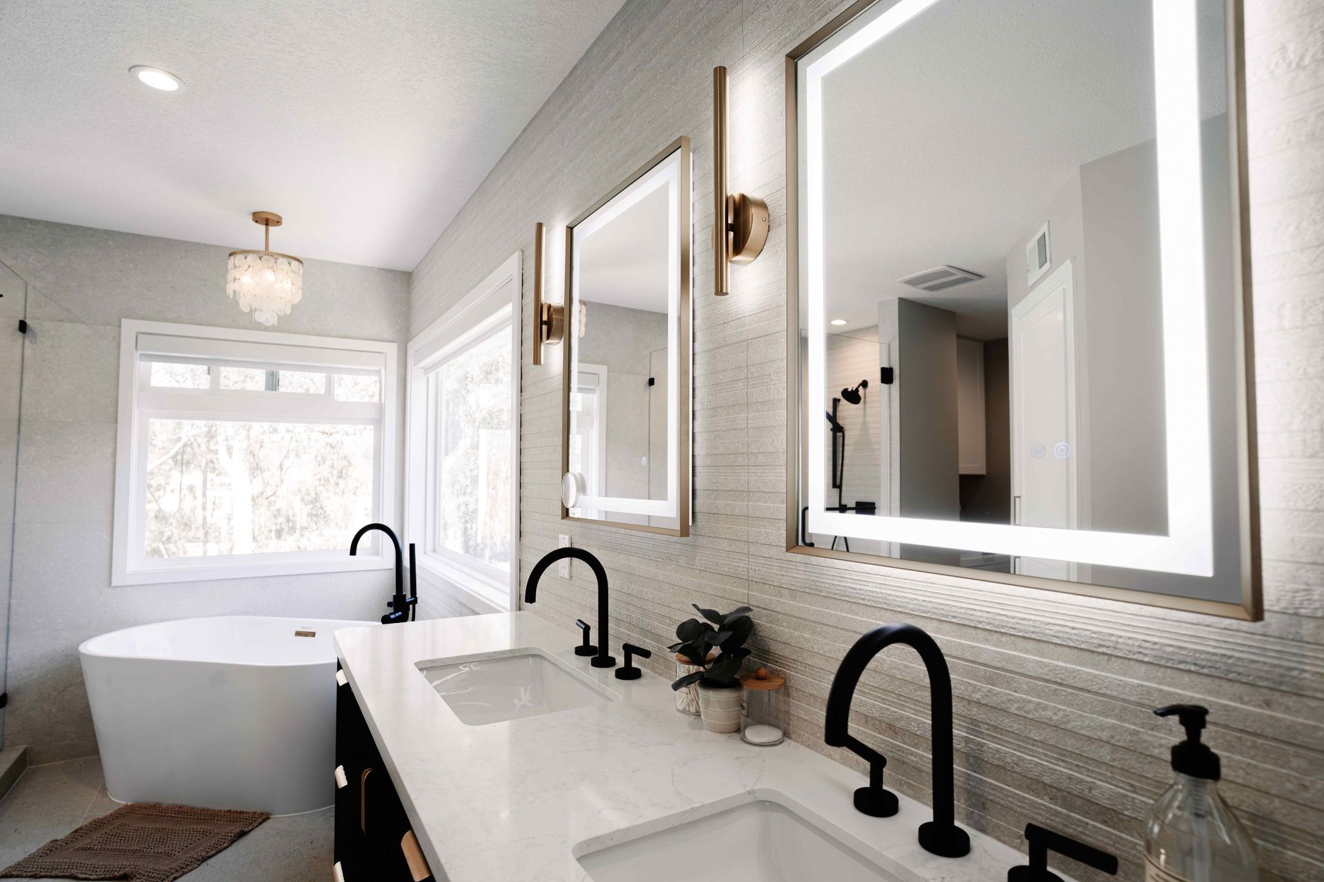 Modern bathroom: white tub, gray shower, white and gray tile, toilet, artwork, and open door.