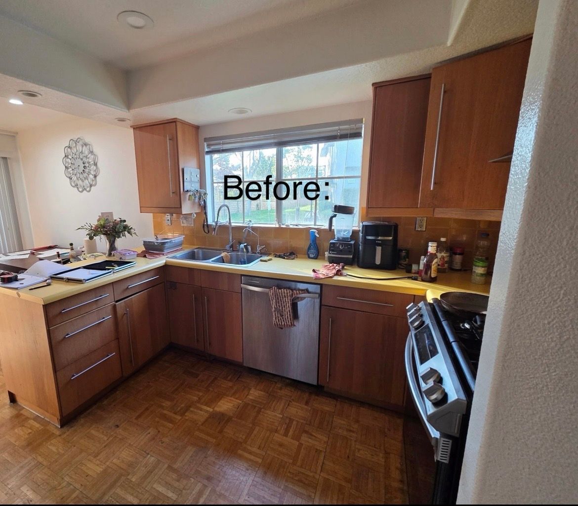 Before photo of a cluttered kitchen with brown cabinets, sink, stove, and dishes on the counters