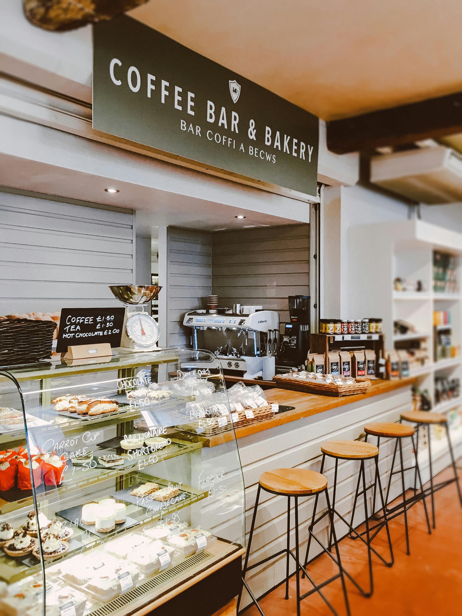 A coffee bar and bakery with a sign above the counter.