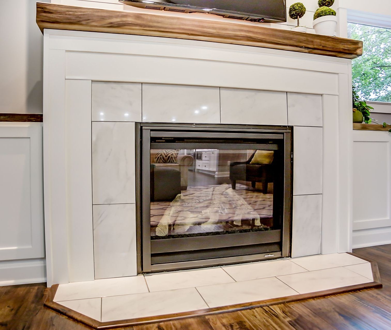 A fireplace with a glass door in a living room