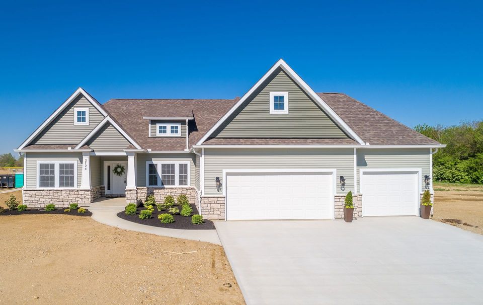 An aerial view of a large house with two garages and a driveway.
