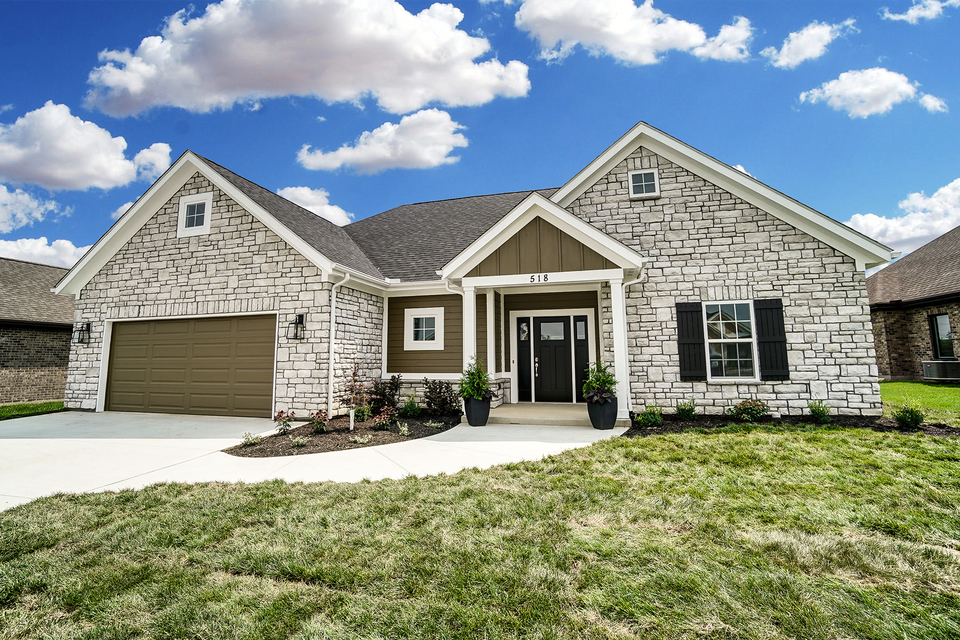 A large house with a lot of grass in front of it.