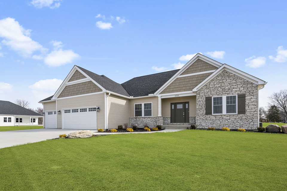 A large house with a large lawn in front of it.