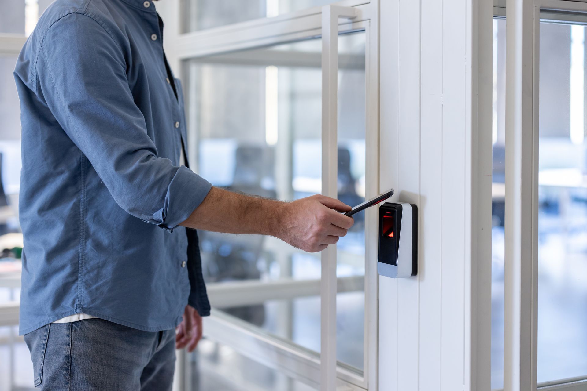 person using a smartphone to access a building with a secure entry system