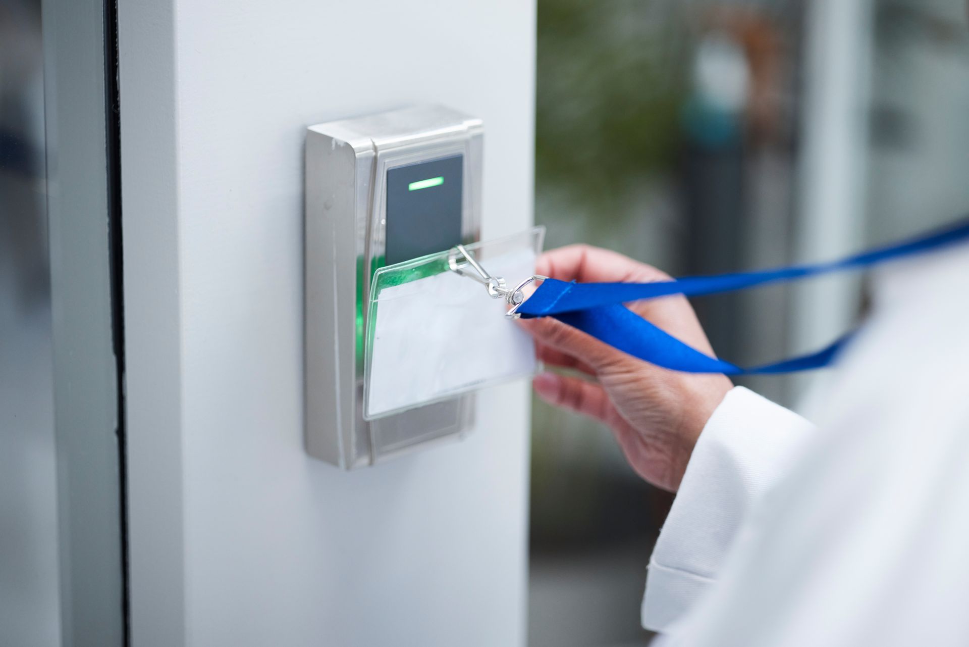 biometric fingerprint scanner mounted on a gray wall next to a glass door with metal handles, used for secure access control biometric fingerprint scanner mounted on a gray wall next to a glass door with metal handles, used for secure access control