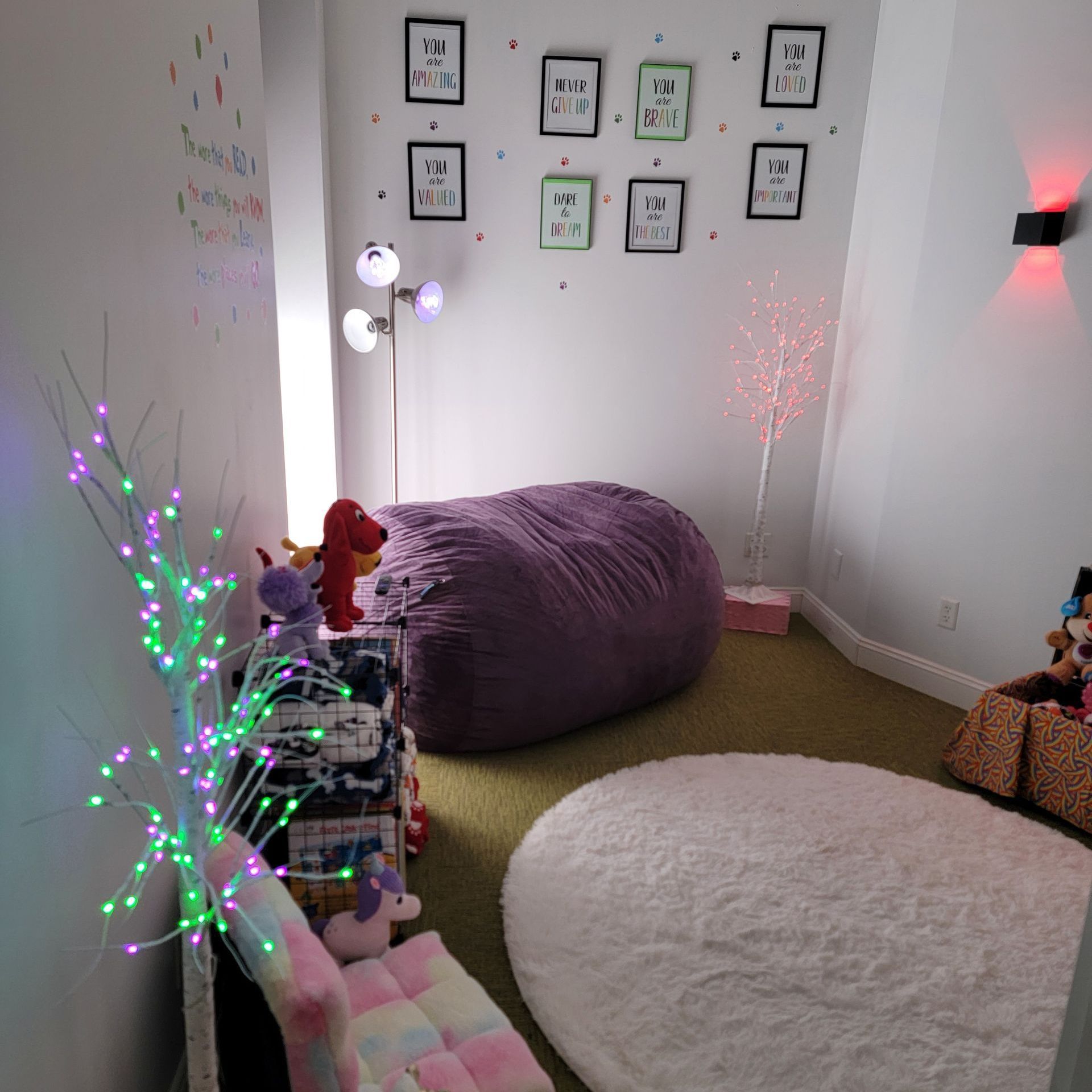 A room with a purple bean bag chair and a white rug