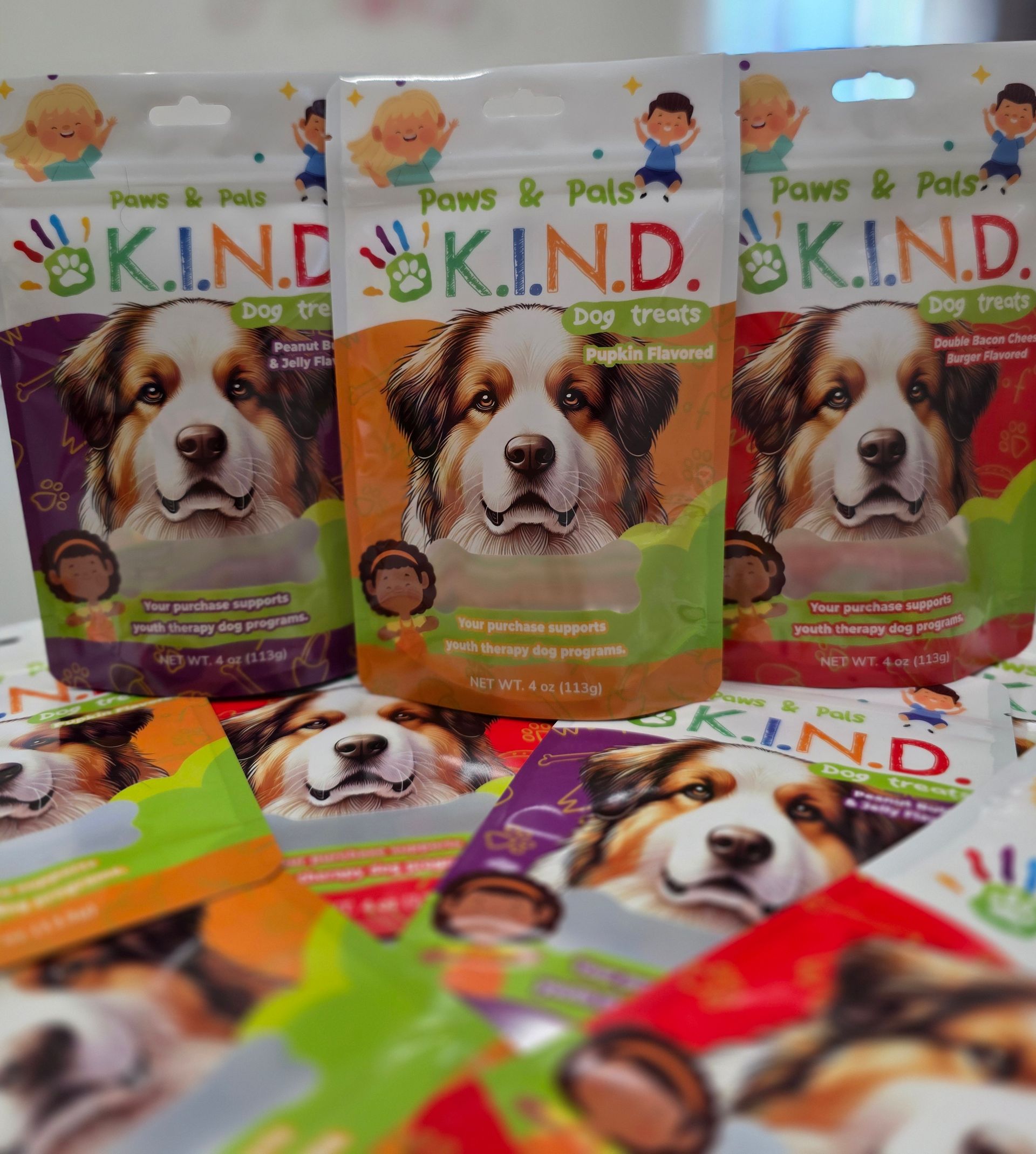 Three bags of kind dog treats are sitting on a shelf