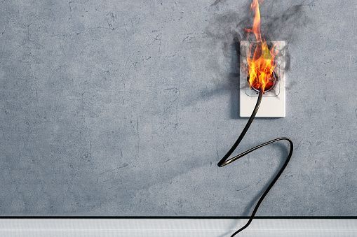 A fire is coming out of an electrical outlet.