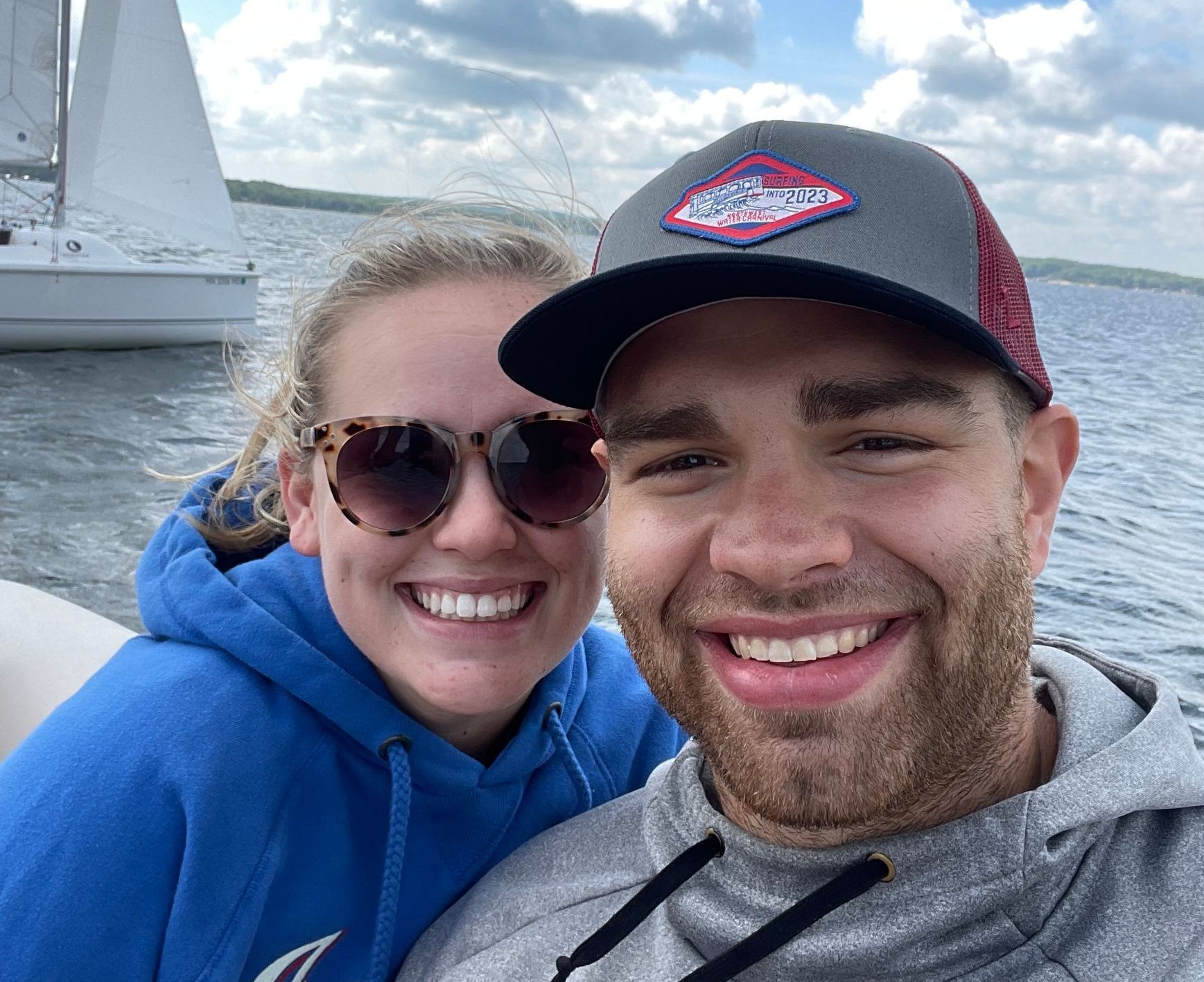 A man and a woman are posing for a picture on a boat.