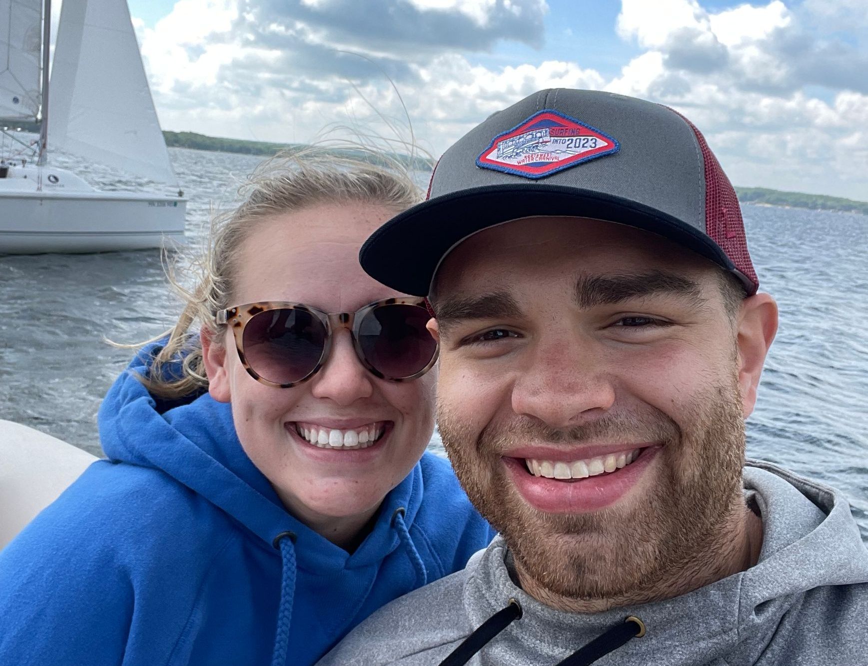 A man and a woman are posing for a picture on a boat.