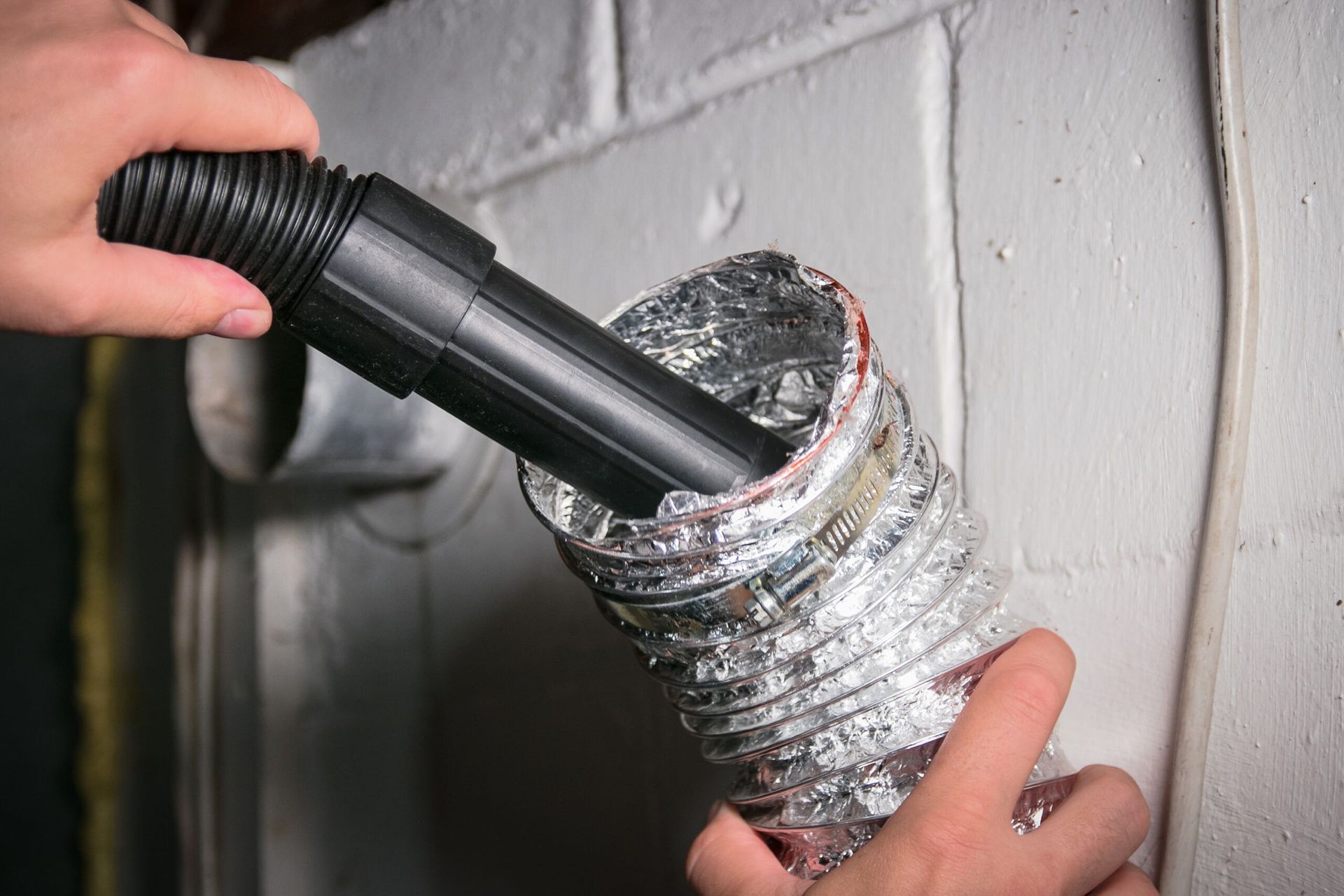 worker repairing ceiling air conditioning