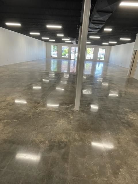 Spacious living room with a comfortable couch and beautiful hardwood flooring.