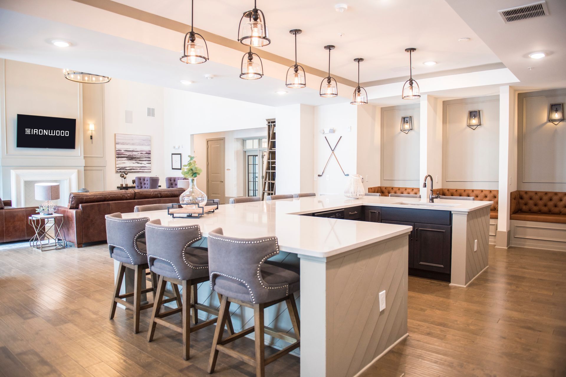 Spacious kitchen with island and bar stools, leading into a living area at Ironwood Apartment Homes.