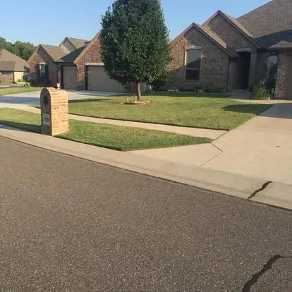 Landscaped front yard maintained by Campbell & Sons
