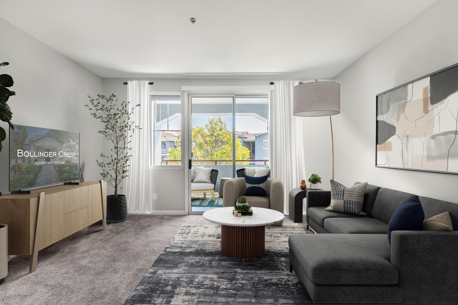 Bright living room with gray sofa, coffee table, TV console, and large window with city view