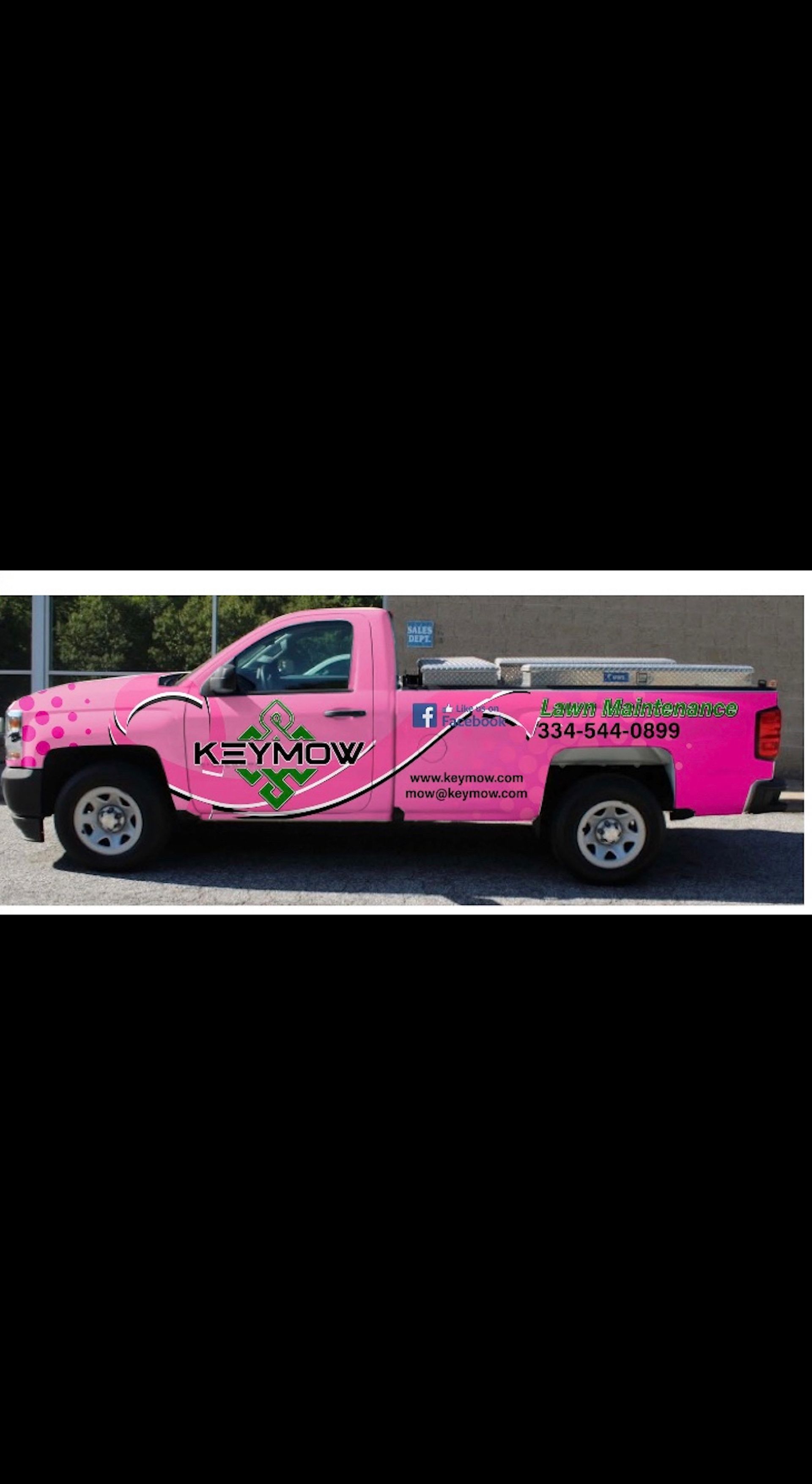 Bright pink pickup truck with black graphics and a covered bed, side view on a white background