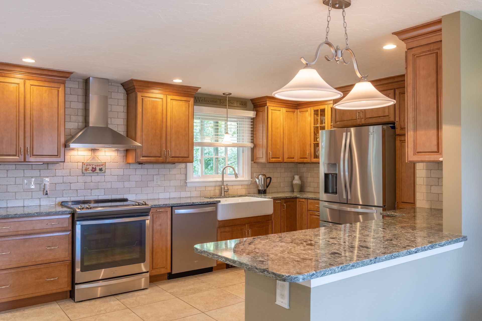 Indianapolis kitchen remodel with wood cabinets, granite counters, and subway tile backsplash