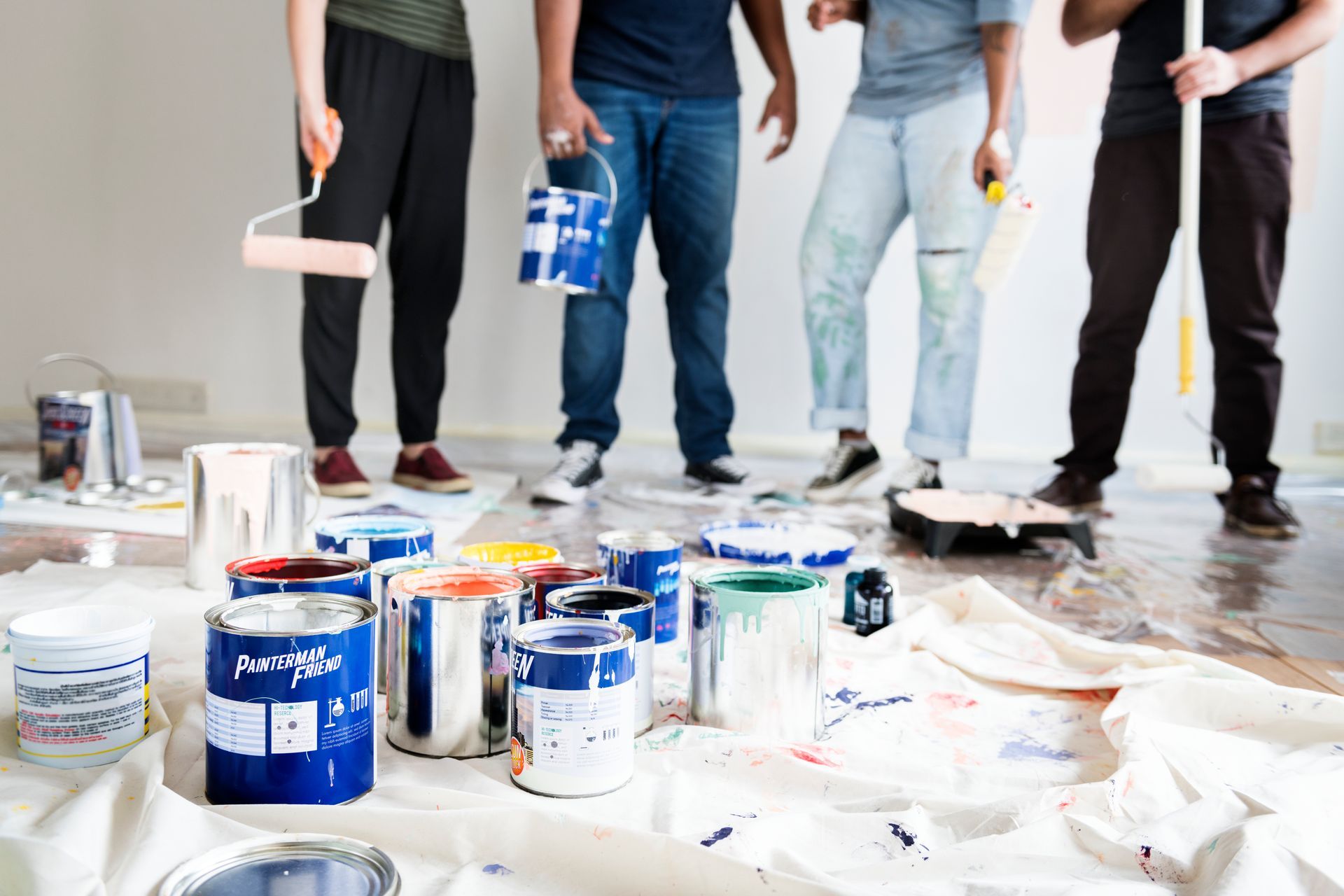 A group of people are painting a room together.