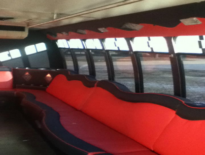 Red and black cushioned seating inside a bus or coach interior