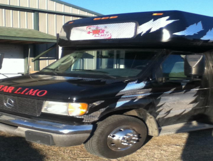Black Star Limo van parked outside a building, with red lettering and a white roof sign.