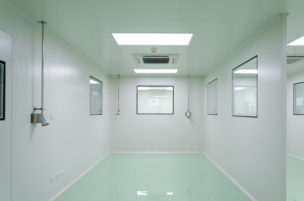 A Clean Room with White Walls and Green Floors in A Factory — Fraser Coast Waterproofing in Hervey Bay, QLD