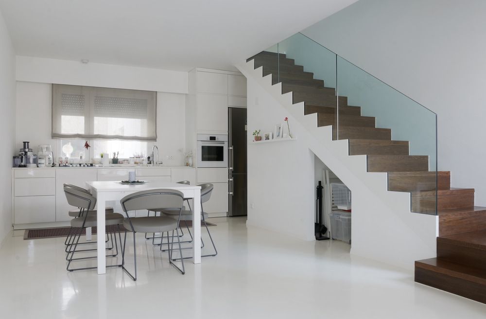 A Kitchen with A Table and Chairs and Stairs — Fraser Coast Waterproofing in Pialba, QLD