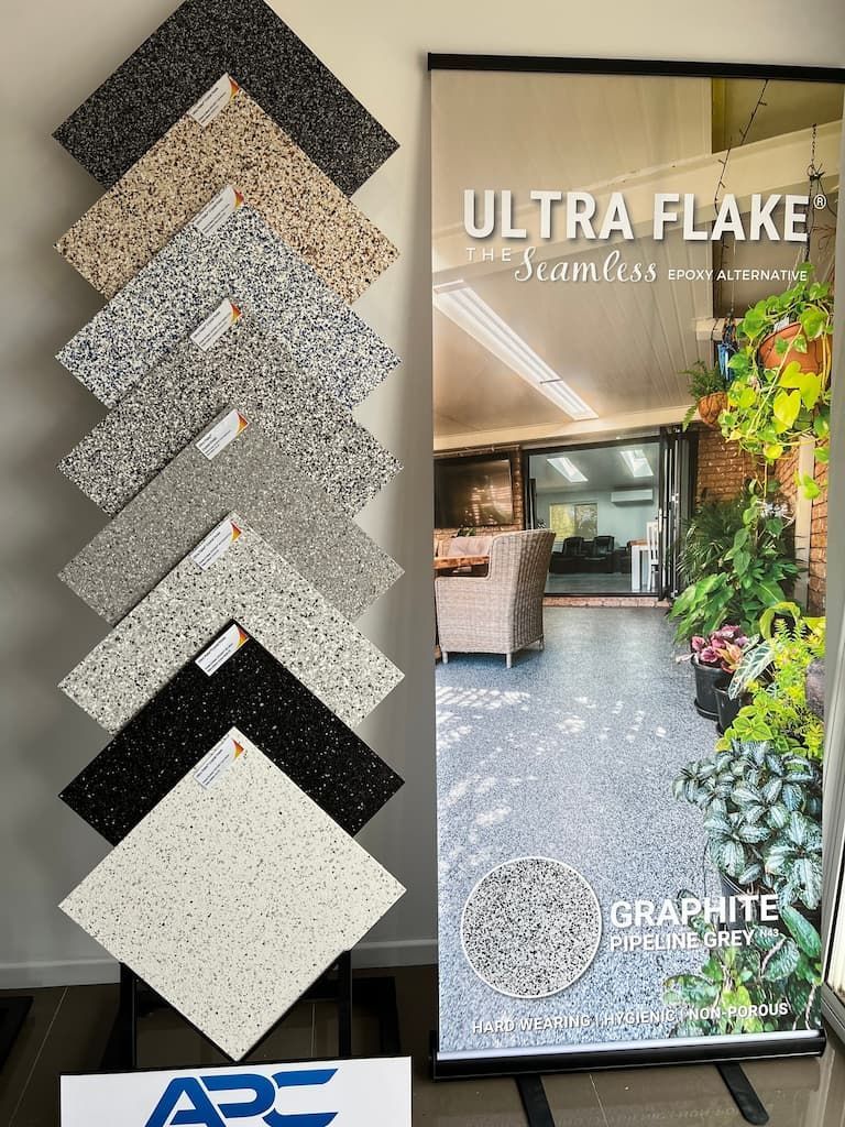 A Display of Tiles and a Sign That Says Ultra Flake — Fraser Coast Waterproofing in Pialba, QLD