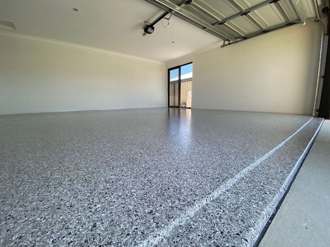 A Garage with A Gray Floor and White Walls — Fraser Coast Waterproofing in Pialba, QLD