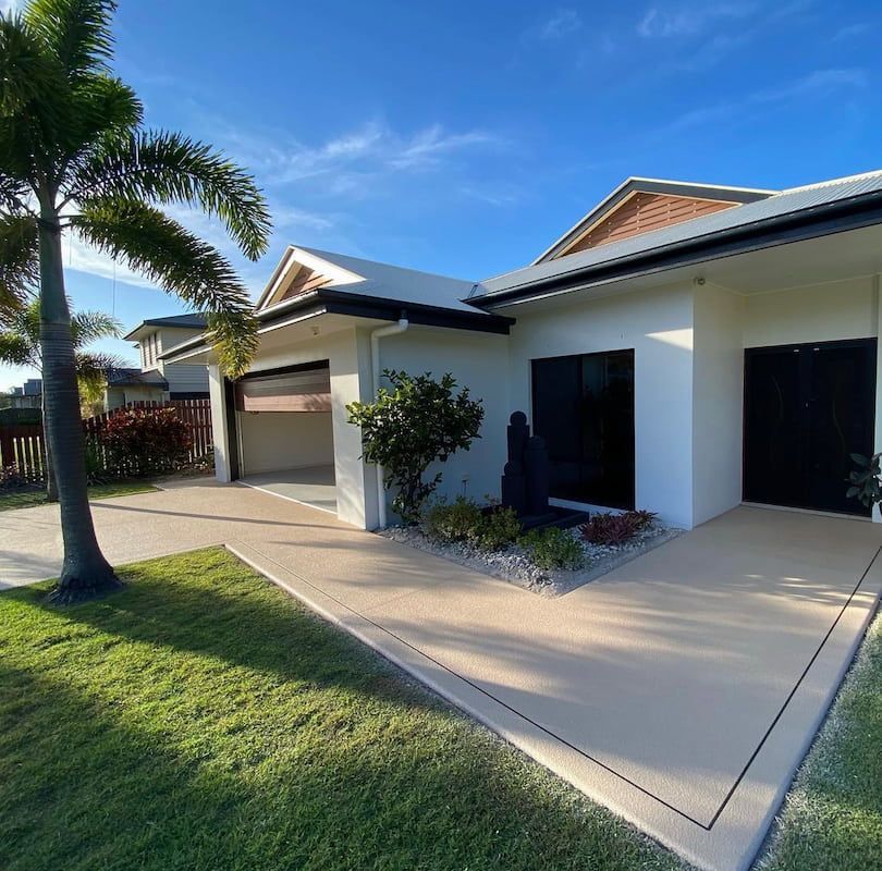 A White House with A Palm Tree in Front of It — Fraser Coast Waterproofing in Pialba, QLD