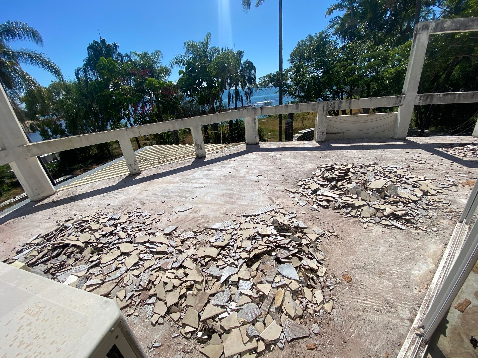 A Man Is Standing in Front of A Display of Tiles  — Fraser Coast Waterproofing in Pialba, QLD