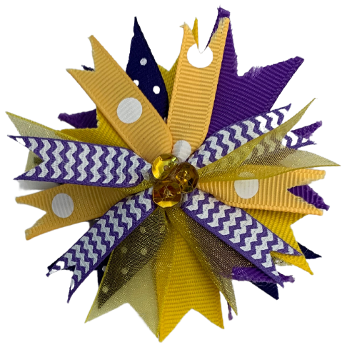 Purple, gold, and white decorative ribbon star with polka dots and chevron patterns, centered on white background